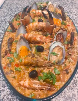 a plate of food with shrimp and other foods at Blue Marlin Hotel in Mindelo