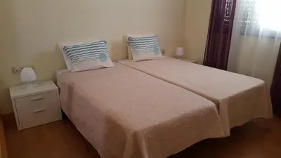 a bedroom with a bed with two pillows on it at Private Apartament Celestina & Carlos in Mindelo
