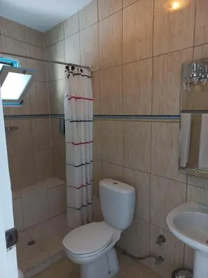 a bathroom with a toilet and a sink at Hotel Savana in São Filipe