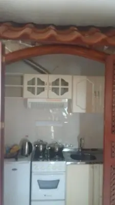 a small kitchen with a stove and a sink at Residencial Cabo Verde Palace in Santa Maria