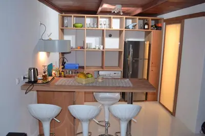 a kitchen with a counter and stools in a room at Studio M in Mindelo