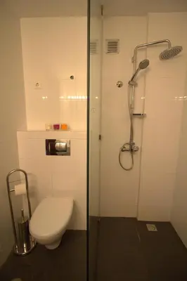 a bathroom with a toilet and a glass shower at Studio M in Mindelo
