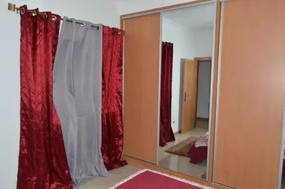 a room with red curtains and a mirror at House Gonçalves in Praia
