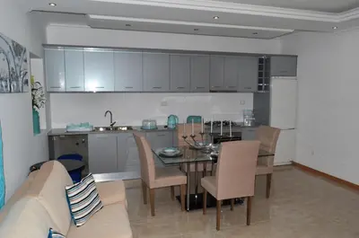 a kitchen and dining room with a table and a couch at House Gonçalves in Praia