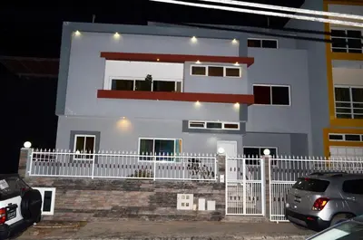 a white house with a white fence in front of it at House Gonçalves in Praia