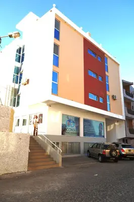 a building with a car parked in front of it at Apartamento Augusto in Praia