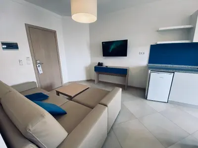 a living room with a couch and a desk at ApartHotel NhaTerra in Santa Maria