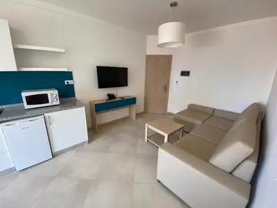 a living room with a couch and a tv at ApartHotel NhaTerra in Santa Maria