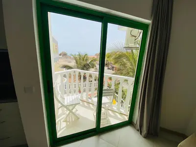 an open window with a view of a balcony at ApartHotel NhaTerra in Santa Maria