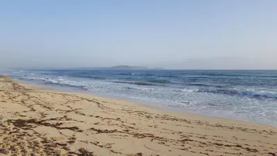 a sandy beach with waves in the ocean at Surf Beach Vila Verde apartments in Santa Maria