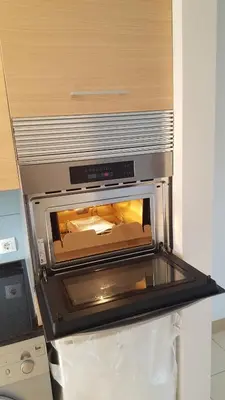 a toaster oven sitting on top of a refrigerator at Surf Beach Vila Verde apartments in Santa Maria