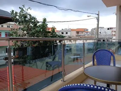 a balcony with a table and chairs on a balcony at Pensao Mille Nuits in Tarrafal
