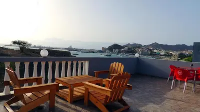 a patio with chairs and a table on a balcony at Mix 2 in Mindelo