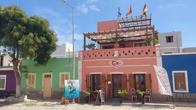 a building with colorful houses on a city street at EMPFEHLUNG der MEERJUNGFRAU in Sal Rei