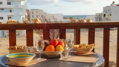 a table with bowls of fruit on a balcony at EMPFEHLUNG der MEERJUNGFRAU in Sal Rei