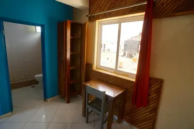 a bathroom with a window and a table and a toilet at Casa Marisa 2.0 in Portela