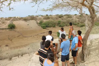 a group of people standing around looking at an elephant at A Caminhada in Morro