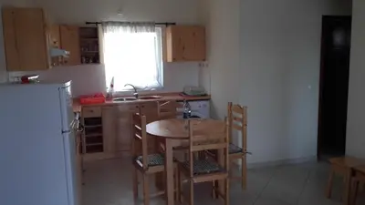 a kitchen with a table and chairs and a sink at A Caminhada in Morro