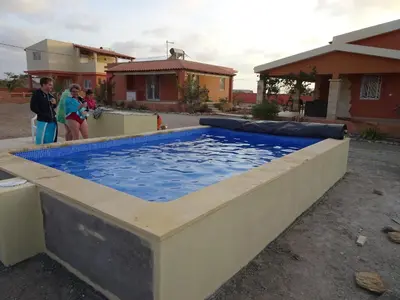 a large pool of water with people standing around it at A Caminhada in Morro