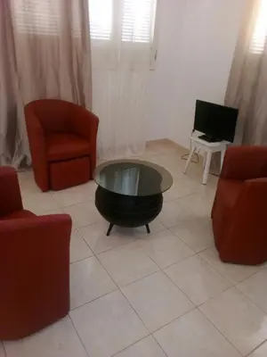 a living room with two chairs and a coffee table at Casa Mendes in Tarrafal