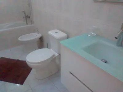 a bathroom with a white toilet and a sink at Casa Mendes in Tarrafal