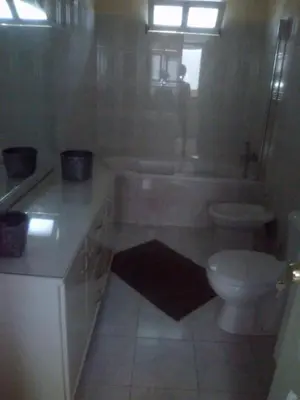 a bathroom with a tub and a toilet and a sink at Casa Mendes in Tarrafal
