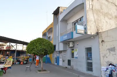 a building with a tree in front of it at Apartamento Justino in Praia