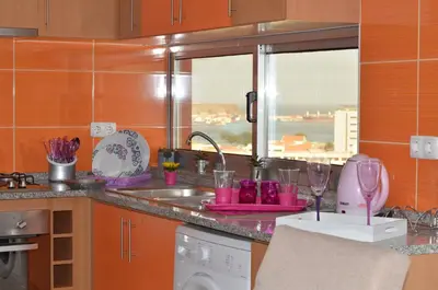 a kitchen with a sink and a counter with a window at Apartamento Justino in Praia