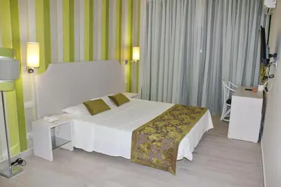 a hotel room with a bed and a television at Ouril Hotel Agueda in Sal Rei