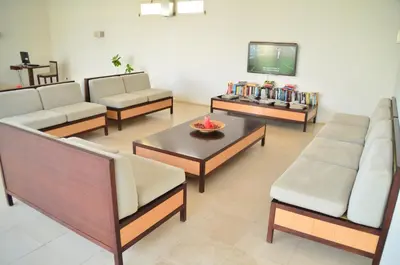a living room with couches and a tv and a table at Hotel Dunas de Sal in Santa Maria