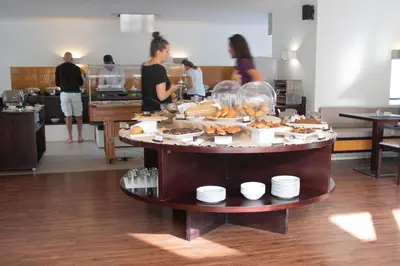 a buffet of food on a table in a kitchen at Hotel Dunas de Sal in Santa Maria