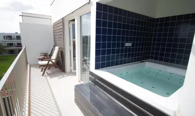 a hot tub on the balcony of a house at Hotel Dunas de Sal in Santa Maria