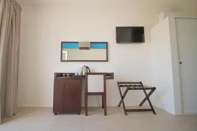 a table and chair in a room with a mirror at Hotel Dunas de Sal in Santa Maria