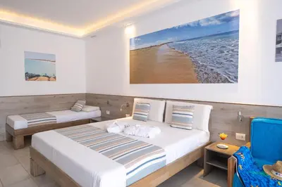 a bedroom with two beds and a blue chair at Sobrado Boutique Hotel in Santa Maria