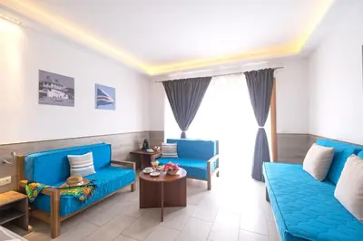 a living room with two blue couches and a table at Sobrado Boutique Hotel in Santa Maria