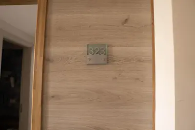 a wooden door with a clock on it at Sobrado Boutique Hotel in Santa Maria