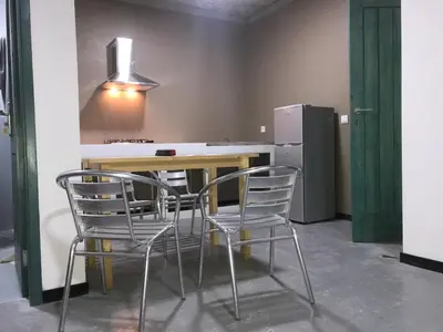 a kitchen with a table and chairs and a refrigerator at Salzen Portas de Sol in Santa Maria