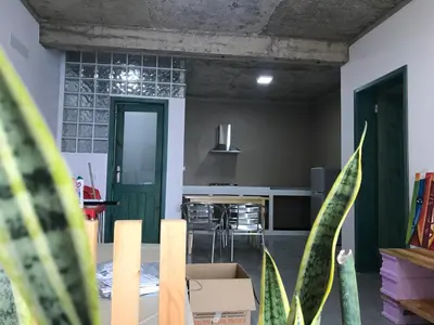 a living room with a table and a kitchen at Salzen Portas de Sol in Santa Maria