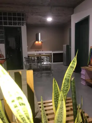 a room with a kitchen and a table with chairs at Salzen Portas de Sol in Santa Maria
