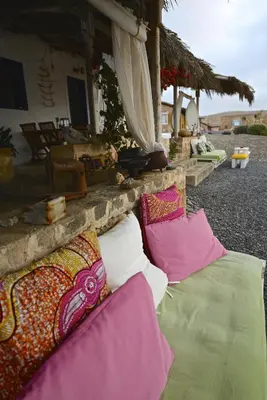 a group of pillows on the ground in front of a building at Spinguera Ecolodge in Espingueira