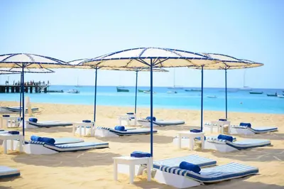 a group of chairs and umbrellas on a beach at Hotel Morabeza in Santa Maria