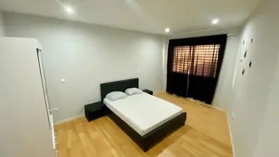 a bedroom with a bed in a room with a window at T1 Família Luz in Mindelo