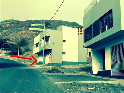 a building on the side of a road next to a building at T1 Família Luz in Mindelo