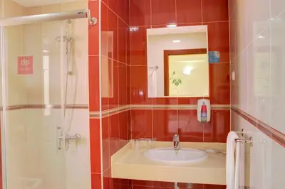 a bathroom with a sink and a shower at Hotel LIVVO Don Paco in Mindelo