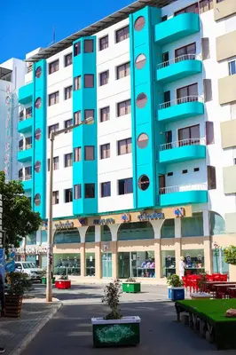 a large blue and white building with a courtyard at Hotel LIVVO Don Paco in Mindelo