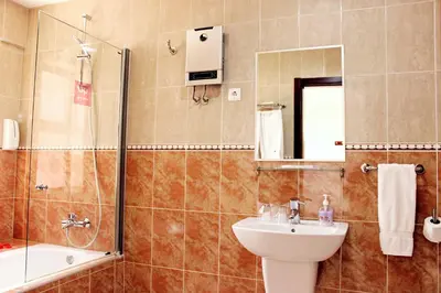 a bathroom with a sink and a shower and a toilet at Hotel LIVVO Don Paco in Mindelo