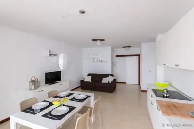 a kitchen and living room with a table and chairs at Apartamento Las Rochas in Mindelo