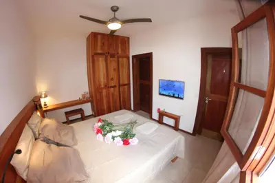a living room with a table with flowers on it at Hotel Casa Evora - luxury and beach front in Vila do Maio