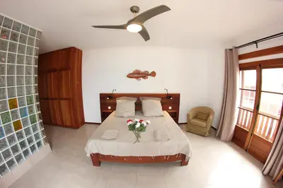 a bedroom with a bed with a vase of flowers on it at Hotel Casa Evora - luxury and beach front in Vila do Maio