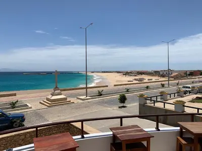 a view of the beach from a balcony of a building at Hotel Casa Evora - luxury and beach front in Vila do Maio